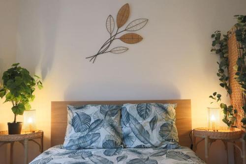 a bedroom with a bed with a plant on the wall at Le Cocon Fleuri, proche centre in Mulhouse