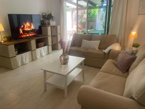 a living room with a couch and a fireplace at La casita de Mon - Radazul in Radazul