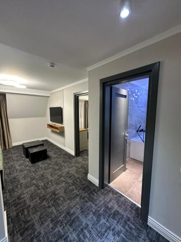 a large room with a door and a television at Hotel Zamca Suceava in Suceava