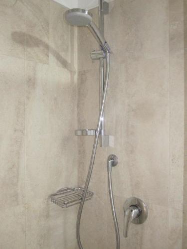 a shower with a shower head in a bathroom at B&B Parva Domus in Lamezia Terme