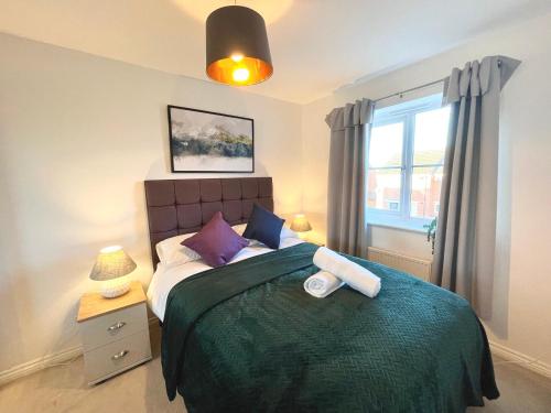 a bedroom with a large bed and a window at Genesis 3 bedroom Home Telford- sleeps up to 5 in Oakengates