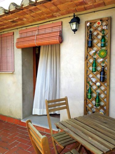 a wooden table and chairs on a patio at Casa El Ros II - Turistrat in Vall dʼAlba