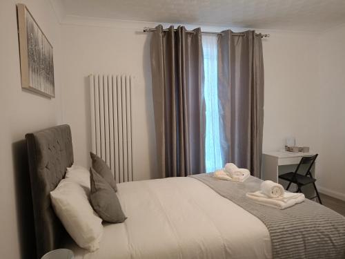 a bedroom with a bed with towels on it at Prestige in Cambridge