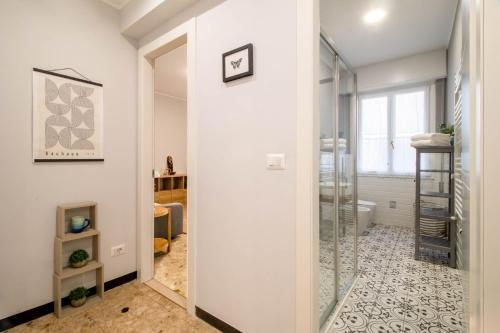 a bathroom with a shower and a glass door at AZURE RETREAT Apartment in Camogli