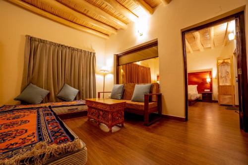 a bedroom with a bed and a couch and a mirror at Royal Soma Resort in Stak