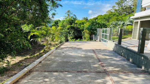 an empty road in front of a house at Suítes Costa Do Macacu-Garopaba in Garopaba