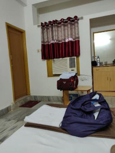a room with a bed and a window with a curtain at Residency 24X7,Bhubaneswar in Bhubaneshwar