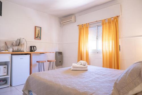 a bedroom with a bed with towels on it at Descanso las Tres Marias Apart Hotel in Villa Carlos Paz