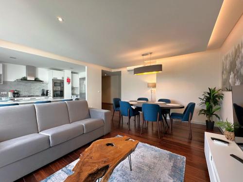 a living room with a couch and a table with chairs at Luxury Apartment in the Center in Funchal