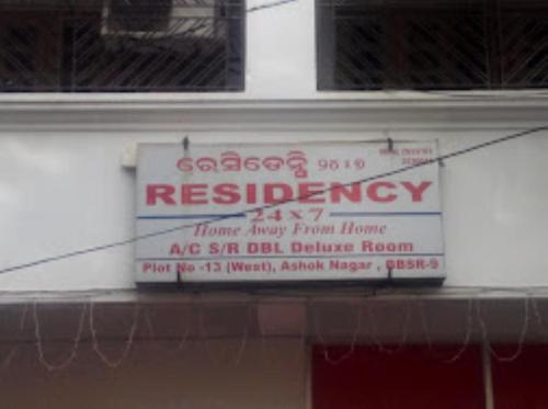 a sign on the side of a building at Residency 24X7,Bhubaneswar in Bhubaneshwar