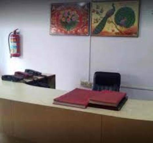 a desk with two red items on top of it at Residency 24X7,Bhubaneswar in Bhubaneshwar
