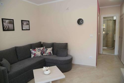 a living room with a couch and a table at Apartments Piano in Utjeha