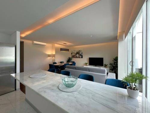 a kitchen and living room with a table and chairs at Luxury Apartment in the Center in Funchal