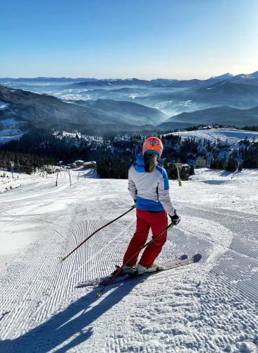 a person on skis standing on a snow covered slope at Vershyna in Dragobrat