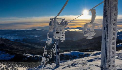 a ski lift on top of a snow covered mountain at Vershyna in Dragobrat