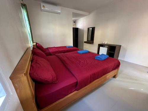 a large bed with red sheets in a bedroom at Sea Shell Beach Resort in Ko Lanta