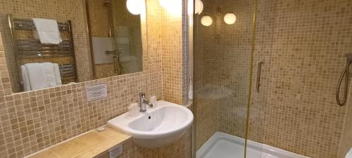 a bathroom with a sink and a shower at Riverdale Hall Hotel & Leisure in Bellingham