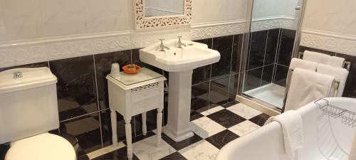 a bathroom with a sink and a toilet at Riverdale Hall Hotel & Leisure in Bellingham