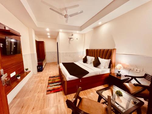 a bedroom with a bed and a living room at The River Grand, Mussoorie in Mussoorie