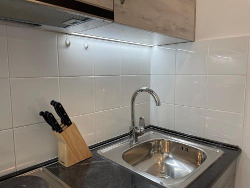 a kitchen sink with a knife block next to it at Cozy 2-room apartment with views in Gudauri