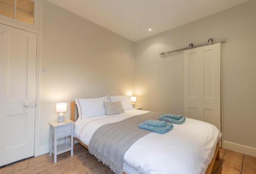 a bedroom with a bed with two towels on it at 33 Victoria Street in Southwold
