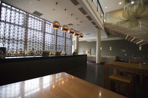 a bar with a wooden table in a restaurant at ibis Sydney Olympic Park in Sydney