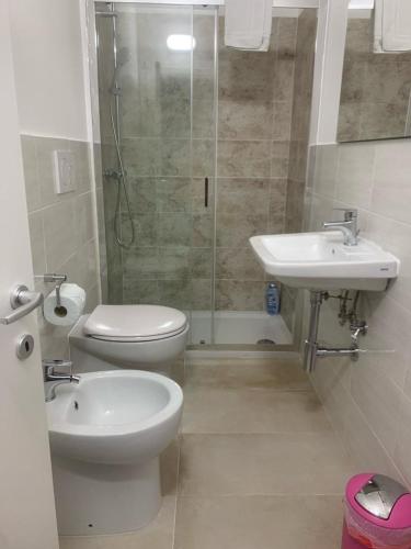 a bathroom with a toilet and a sink and a shower at La casa di Gio' in Fiumicino