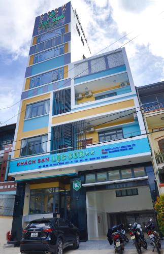 a building with motorcycles parked in front of it at Lộc Sơn Hotel in Buon Ma Thuot