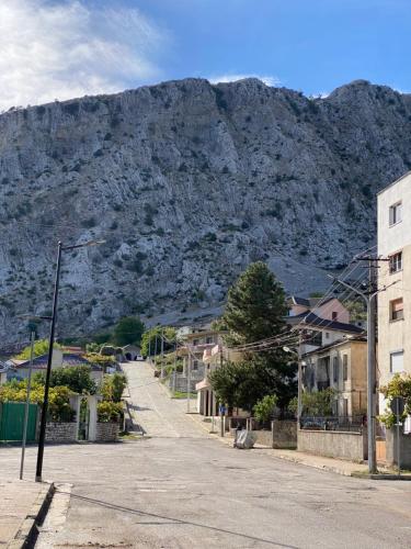 an empty street with a mountain in the background at 4 Seasons Apartment in Leskovik