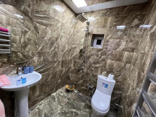 a bathroom with a toilet and a sink at JLYN HOUSE in İsmayıllı