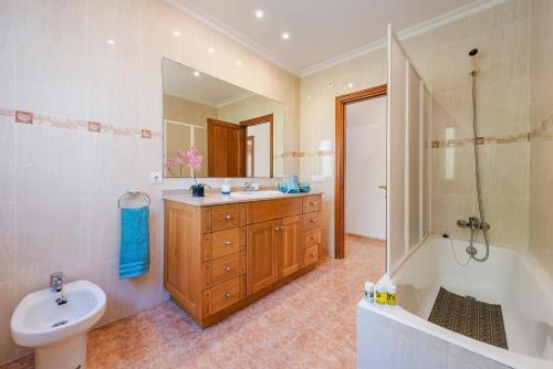 Villa Manresa in Alcudia by JS Villas في الكوذيا: حمام مع حوض وحوض استحمام ومرحاض