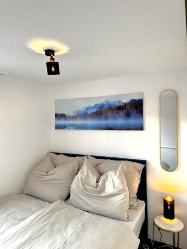 a bedroom with a bed with white pillows at Zentrale Wohnung mit Dachterasse in Bregenz