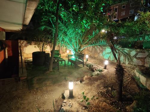 a garden at night with lights and a bench at La Palace Exclusive Design in Istanbul