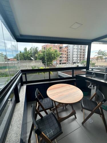 a table and chairs on the roof of a building at Blue Beach Beira Mar in Cabedelo