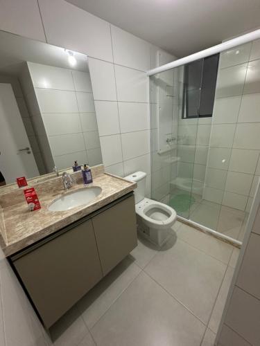 a bathroom with a toilet and a sink and a shower at Blue Beach Beira Mar in Cabedelo