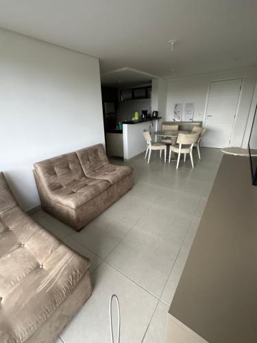 a living room with a couch and a table at Blue Beach Beira Mar in Cabedelo