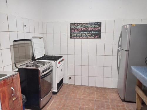 a kitchen with a stove and a refrigerator at Origenes in Santiago