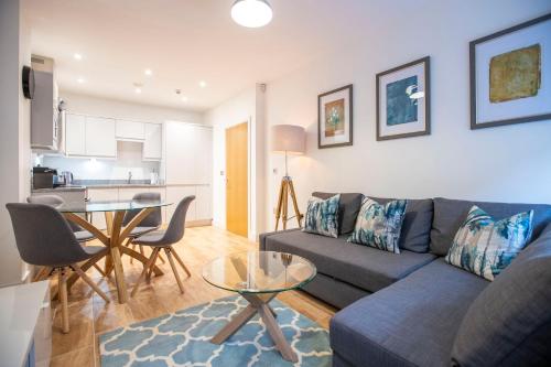 a living room with a couch and a table at Urban Living's - King Edward Luxury Suites in Windsor