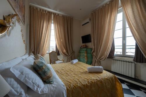 a bedroom with a large bed in a room with windows at San Giorgio Rooms in Genova