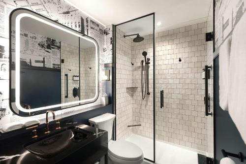 a bathroom with a shower and a sink and a toilet at Onyx Boston Downtown in Boston