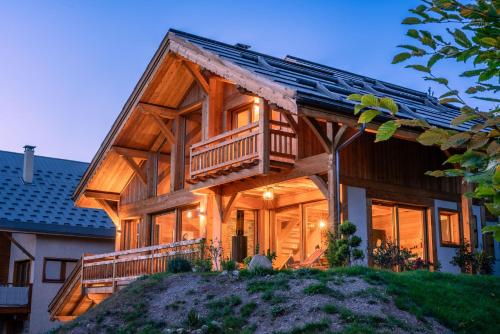 a log home with a wrap around deck at Chalet Ski Académie - Serre Chevalier in Saint-Chaffrey