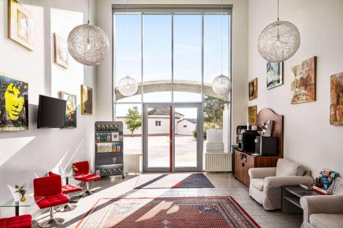 a living room with a large glass door at Amedia Express Sattledt, Trademark Collection by Wyndham in Sattledt
