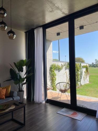 a living room with a large sliding glass door at Villa Ambassadori Kachreti Golf Resort, Kakheti Kachreti in Kachretʼi