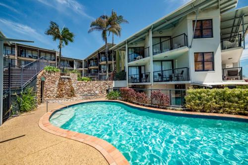 a swimming pool in front of a building at Hear the Sea 2 mins from Coolum beach and shops in Coolum Beach