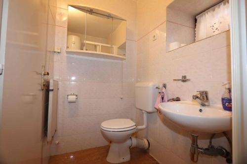 a bathroom with a toilet and a sink at Holiday home in Silo/Insel Krk 26681 in Šilo