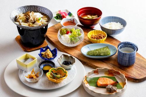 a table with plates of food and bowls of food at Shima Yamaguchikan in Nakanojo