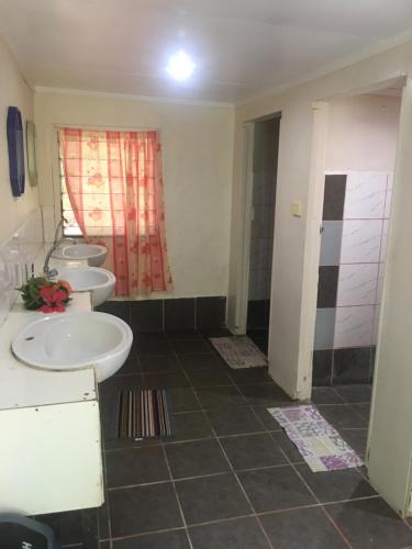 a bathroom with two sinks and two toilets at Yasawa Long Beach Hideout Resort in Vuake