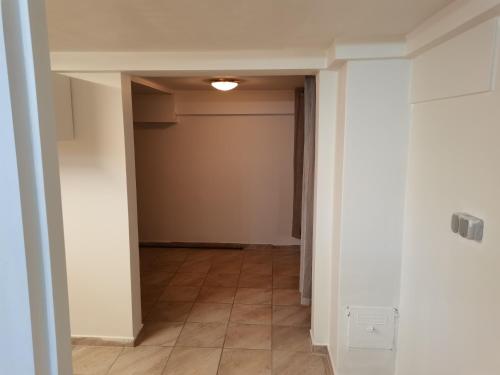 an empty hallway with a door and a tile floor at Keflavik Cozy Apartment in Keflavík