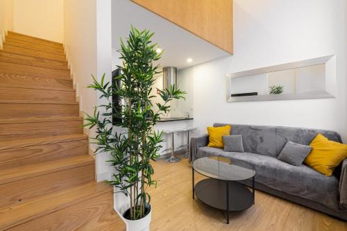 a living room with a couch and a plant at GuestReady - King House 3 in Porto