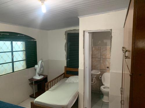 a small bathroom with a bed and a toilet at Samambaia 01 in Brasilia